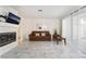 Bright living room with a tiled fireplace, light marble floors, and sheer curtains at 4869 S Torrey Pines Dr # 101, Las Vegas, NV 89103
