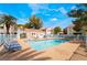 Community pool with lounge chairs and seating areas for residents to relax and enjoy the outdoors at 4869 S Torrey Pines Dr # 101, Las Vegas, NV 89103