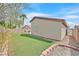 Backyard with an artificial lawn, brick accents, a small patio and privacy walls at 4920 River Splash Ave, Las Vegas, NV 89131