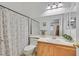 Functional bathroom with a single vanity, toilet, shower-tub combination, and a decorative shower curtain at 4920 River Splash Ave, Las Vegas, NV 89131