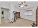 Bright bedroom features light-colored walls, a ceiling fan, and ample space for storage and personal items at 4920 River Splash Ave, Las Vegas, NV 89131