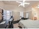 Bright bedroom featuring neutral walls, a ceiling fan, an ensuite, and a dedicated workout and office space at 4920 River Splash Ave, Las Vegas, NV 89131