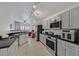 Open kitchen with stainless steel appliances, granite countertops, and a view into the living room at 4920 River Splash Ave, Las Vegas, NV 89131