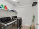 Laundry room featuring a modern washer and dryer, a shelving unit, and space for laundry essentials at 4920 River Splash Ave, Las Vegas, NV 89131