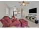Comfortable living room space with tile floors leading to the kitchen and dining area at 4920 River Splash Ave, Las Vegas, NV 89131