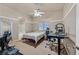 Spacious primary bedroom with neutral decor, carpet floors, fan, and an ensuite bathroom at 4920 River Splash Ave, Las Vegas, NV 89131