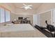 Bright primary bedroom with carpet flooring, neutral paint, large windows, and ceiling fan at 4920 River Splash Ave, Las Vegas, NV 89131