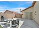 Enclosed patio features seating, barbecue, and backyard access through a sliding glass door at 4920 River Splash Ave, Las Vegas, NV 89131