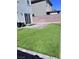 Lush backyard featuring artificial turf and a patio at 4993 Birchland Manor Ave, Las Vegas, NV 89139