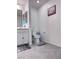 Neutral bathroom features white toilet, grey floor, and small vanity area at 4993 Birchland Manor Ave, Las Vegas, NV 89139