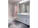 Bright bathroom features double sink vanity, shower over tub, and neutral color scheme at 4993 Birchland Manor Ave, Las Vegas, NV 89139