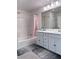 Bright bathroom features double sink vanity, shower over tub, and neutral color scheme at 4993 Birchland Manor Ave, Las Vegas, NV 89139