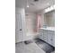 Bright bathroom features double sink vanity, shower over tub, and neutral color scheme at 4993 Birchland Manor Ave, Las Vegas, NV 89139