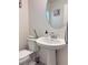 Half bathroom featuring pedestal sink, artwork and modern fixtures at 4993 Birchland Manor Ave, Las Vegas, NV 89139