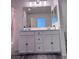 Bright bathroom features double sink vanity, shower over tub, and neutral color scheme at 4993 Birchland Manor Ave, Las Vegas, NV 89139