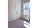 Carpeted bedroom features natural light, a door, and neutral wall color at 4993 Birchland Manor Ave, Las Vegas, NV 89139