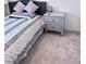 Cozy bedroom showcasing a nightstand with drawers and a stylish lamp, offering a tranquil atmosphere at 4993 Birchland Manor Ave, Las Vegas, NV 89139