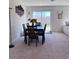 Dining room with table set and a sliding glass door to the backyard at 4993 Birchland Manor Ave, Las Vegas, NV 89139