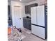 Kitchen with gray cabinets, granite countertops, stainless refrigerator, and a convenient utility cart at 4993 Birchland Manor Ave, Las Vegas, NV 89139