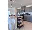 Modern kitchen featuring gray cabinets, granite countertops, stainless steel appliances, and a kitchen island with pendant lighting at 4993 Birchland Manor Ave, Las Vegas, NV 89139