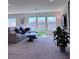 Comfortable living room featuring a plush couch, a large window, and modern decor at 4993 Birchland Manor Ave, Las Vegas, NV 89139