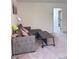 Living room with a gray sectional sofa, a modern lamp, and a dark gray coffee table at 4993 Birchland Manor Ave, Las Vegas, NV 89139