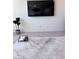 Modern living room featuring a sleek marble coffee table and wall mounted TV at 4993 Birchland Manor Ave, Las Vegas, NV 89139