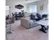 Open living room featuring carpet floors, a couch, a dining table, and counter seating at 4993 Birchland Manor Ave, Las Vegas, NV 89139