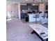 Open-concept living space with a kitchen, living room, and dining area with gray cabinets and granite countertops at 4993 Birchland Manor Ave, Las Vegas, NV 89139