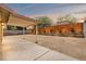 Spacious backyard featuring a covered patio, gravel, and a wooden fence at 5001 Morris St, Las Vegas, NV 89122