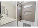 Updated bathroom features a tiled shower with a built-in niche, and a marble countertop at 5001 Morris St, Las Vegas, NV 89122
