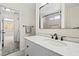 Clean bathroom with a marble vanity, framed mirror, and tiled shower at 5001 Morris St, Las Vegas, NV 89122