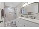Updated bathroom with double vanity, walk-in shower, and neutral tiling at 5001 Morris St, Las Vegas, NV 89122