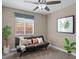 Neutral bedroom with a cozy futon, ceiling fan, window, and plant at 5001 Morris St, Las Vegas, NV 89122