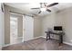 Bright bedroom with a barn door leading to bathroom, computer, and a ceiling fan at 5001 Morris St, Las Vegas, NV 89122