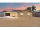 Back exterior of the house featuring covered patio and simple desert landscaping at 5001 Morris St, Las Vegas, NV 89122