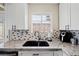 Bright kitchen showcasing granite countertops, stainless steel sink, and tiled backsplash at 5001 Morris St, Las Vegas, NV 89122