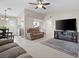 Comfortable living room featuring tile floors, neutral walls, and an entertainment center with a fireplace at 5001 Morris St, Las Vegas, NV 89122