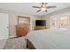 Comfortable main bedroom with TV, ceiling fan, and backyard access at 5001 Morris St, Las Vegas, NV 89122