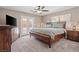 Spacious main bedroom with ceiling fan, carpet, and access to the backyard at 5001 Morris St, Las Vegas, NV 89122