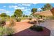 Landscaped backyard featuring a covered patio, mature trees, and scenic views at 5029 Pacific Grove Dr, Las Vegas, NV 89130
