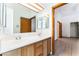 Bright bathroom with a dual sink vanity, framed mirror, and updated lighting fixtures at 5029 Pacific Grove Dr, Las Vegas, NV 89130