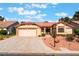 Charming one-story home featuring a well-maintained lawn, two-car garage, and desert landscaping at 5029 Pacific Grove Dr, Las Vegas, NV 89130