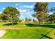 Lush green golf course with mature trees, blue skies, and scenic landscaping at 5029 Pacific Grove Dr, Las Vegas, NV 89130