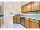 Kitchen featuring wood cabinets, stainless steel appliances, ample counter space, and a breakfast nook with bright windows at 5029 Pacific Grove Dr, Las Vegas, NV 89130