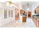 Open kitchen with light wood cabinets, stainless steel appliances, and tiled floors, seamlessly connecting to other spaces at 5029 Pacific Grove Dr, Las Vegas, NV 89130