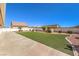 Spacious backyard features artificial turf, gravel landscaping, and a pristine white fence at 5231 E Chasemoor St, Pahrump, NV 89061