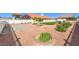 Expansive backyard boasting gravel landscaping, mature trees, and a white fence at 5231 E Chasemoor St, Pahrump, NV 89061