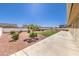 Large backyard featuring manicured landscaping and a concrete patio area at 5231 E Chasemoor St, Pahrump, NV 89061