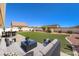 Spacious backyard featuring a plush lawn, patio seating and manicured landscaping at 5231 E Chasemoor St, Pahrump, NV 89061